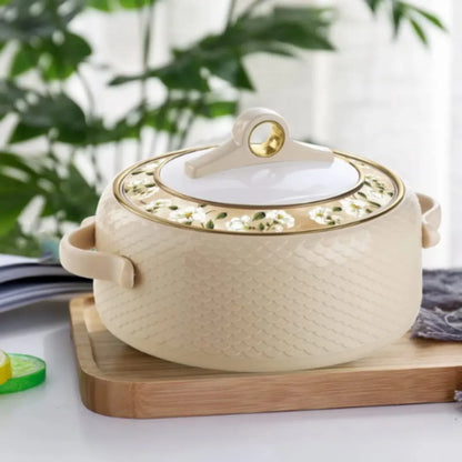 NAYASA Coral Casserole Light Brown, a white ceramic pot with lid on a wooden cutting board.