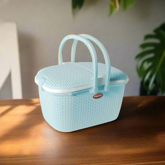 A CLASSIC WOVEN PICNIC BASKET WITH INTRICATE DETAILING AND STURDY HANDLES.